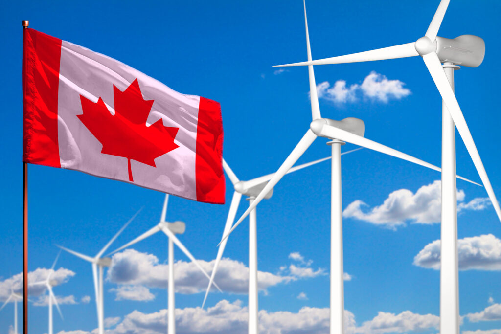 Moinhos de vento ao lado da bandeira do Canadá. A imagem simboliza o poder da exportação de energia eólica do Canadá.